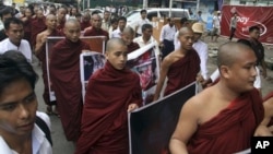 Buddhist monks march to protest against crackdown on protesters at the Letpadaung copper mine in Monywa, northwestern Myanmar, in Yangon, Myanmar, Friday, Nov. 30, 2012. Opposition leader Aung San Suu Kyi publicly criticized the forcible crackdown on prot