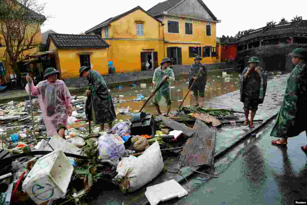 Vietnam soldiers clean debris caused by flooding by Typhoon Damrey in the ancient UNESCO heritage town of Hoi An, Vietnam November 8, 2017..