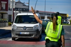 Spanish Civil Guards on a checkpoint for all residents of the small village of Alfaro, La Rioja Province, northern Spain, which has been placed in lockdown due to a coronavirus outbreak, Sept. 8, 2020.