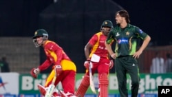 file: Zimbabwe's Vasimuzi Sibanda, and Sean Williams, left, run between the wickets as Pakistani bowler Anwar Ali looks on during a match at the Gaddafi Stadium in Lahore, Pakistan, Sunday, May 24, 2015. 