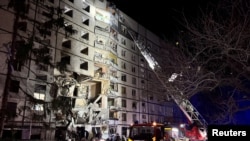 Rescuers work at the site where an apartment building was hit by a Russian air strike, amid Russia's attack on Ukraine, in Kharkiv, Ukraine October 30, 2024.