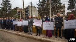 FILE - Protesters demonstrate outside a U.N. building, in the northeast city of Qamishli, Nov. 28, 2021. Numerous journalists covering a demonstration on Dec. 7, 2021, were temporarily detained.