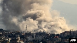 Thick smoke rises from explosions as Israeli forces reportedly demolish dwellings in the border town of Khiam in southern Lebanon, on Dec. 1, 2024, days into a fragile ceasefire between Israel and Hezbollah.