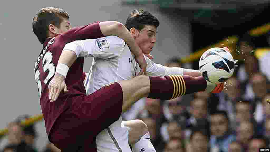 Tottenham Hotspur's Gareth Bale (R) challenges Manchester City's Matija Nastasi during their English Premier League soccer match at White Hart Lane in London April 21, 2013. REUTERS/Stefan Wermuth (BRITAIN - Tags: SPORT SOCCER) NO USE WITH UNAUTHORIZED A