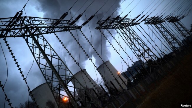 FILE - Water vapor rises from the cooling towers of the Jaenschwalde coal-fired power plant of Lausitz Energie Bergbau AG in Jaenschwalde, Germany, Jan. 24, 2019.