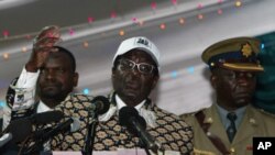 Zimbabwe's President and leader of ZANU-PF Robert Mugabe (C) delivers a speech at the party's 12th National People's Conference in Bulawayo, December 10, 2011.