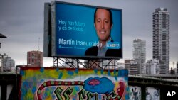 A photo of candidate Martin Insaurralde of the ruling Frente para la Victoria party, or Front for Victory, appears in a banner that reads in Spanish "Today there is a future and it belongs to all of us" in Buenos Aires, Oct. 23, 2013. 