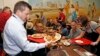 Arizona Cardinals team president Michael Bidwill, left, joins other players and staff of the Cardinals NFL football team as they serve Thanksgiving dinner at the Phoenix Rescue Mission at the 15th annual 'Feed the Hungry' event, Nov. 21, 2016, in Phoenix.