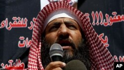 FILE - Mohammad al-Shalabi, better known as Abu Sayyaf, speaks to a crowd of about 200 calling for the release of prisoners outside the Prime Minister office in Amman, Jordan, Sept. 9 2012.