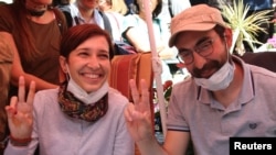 Nuriye Gulmen, a literature professor, and Semih Ozakca, a primary school teacher, who have been on hunger strike after they both lost their jobs in a crackdown following a failed July coup against President Tayyip Erdogan, take part in a protest against 