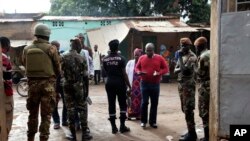 Security officers stand guard in front of a polling station during presidential elections, in Bamako, Mali, July 29, 2018.