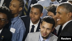 U.S. President Barack Obama, right, poses with students at New York's Lehman College after announcing the launch of My Brother's Keeper Alliance, May 4, 2015.