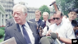 FILE - Former U.S. President Jimmy Carter leaves the White House, June 19, 1994, in Washington after he briefed top administration officials on his recent trip to North Korea.