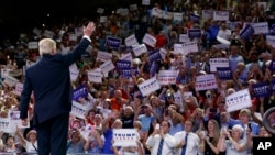 Republican presidential candidate Donald Trump waves to the crowd as he arrives at a campaign rally at the University of North Carolina Wilmington, in Wilmington, N.C., Aug. 9, 2016. 