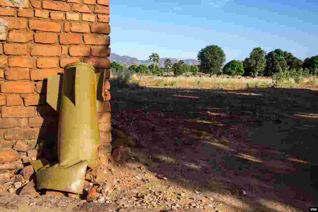 An un-exploded bomb sits against a wall in Kowdah town. One of over 2000 bombs dropped out of Antonov planes in the Nuba Mountains since 2012. (Adam Bailes/VOA News)