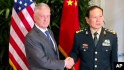 U.S. Defense Secretary Jim Mattis, left, meets with Chinese Defense Minister Wei Fenghe in Singapore, Oct. 18, 2018.