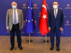Turkey's Foreign Minister Mevlut Cavusoglu, right, and Josep Borrell Fontelles, High Representative and Vice-President of the European Commission, pose for photos before a meeting, in Ankara, Turkey, July 6, 2020.