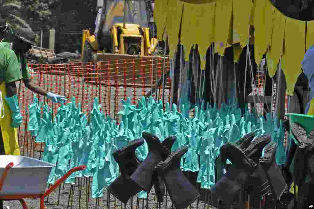 Ebola health care workers&#39; protective gear, including gloves and rubber boots, dries in the sun after being washed at a clinic in Monrovia, Liberia, Sept. 8, 2014.&nbsp;