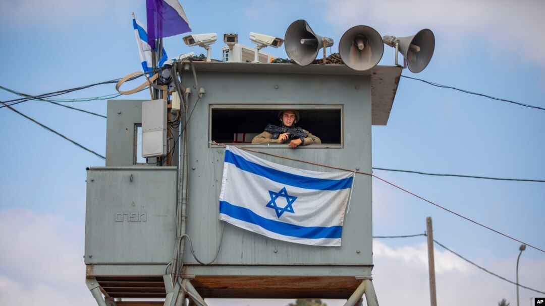 An Israeli soldier stands guard at the Tapuach junction next to the West Bank city of Nablus, June 30, 2020.