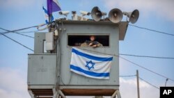 An Israeli soldier stands guard at the Tapuach junction next to the West Bank city of Nablus, June 30, 2020.