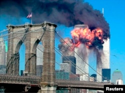 The second tower of the World Trade Center bursts into flames after being hit by a hijacked airplane in New York in this September 11, 2001 file photograph. (REUTERS/Sara K. Schwittek/Files)