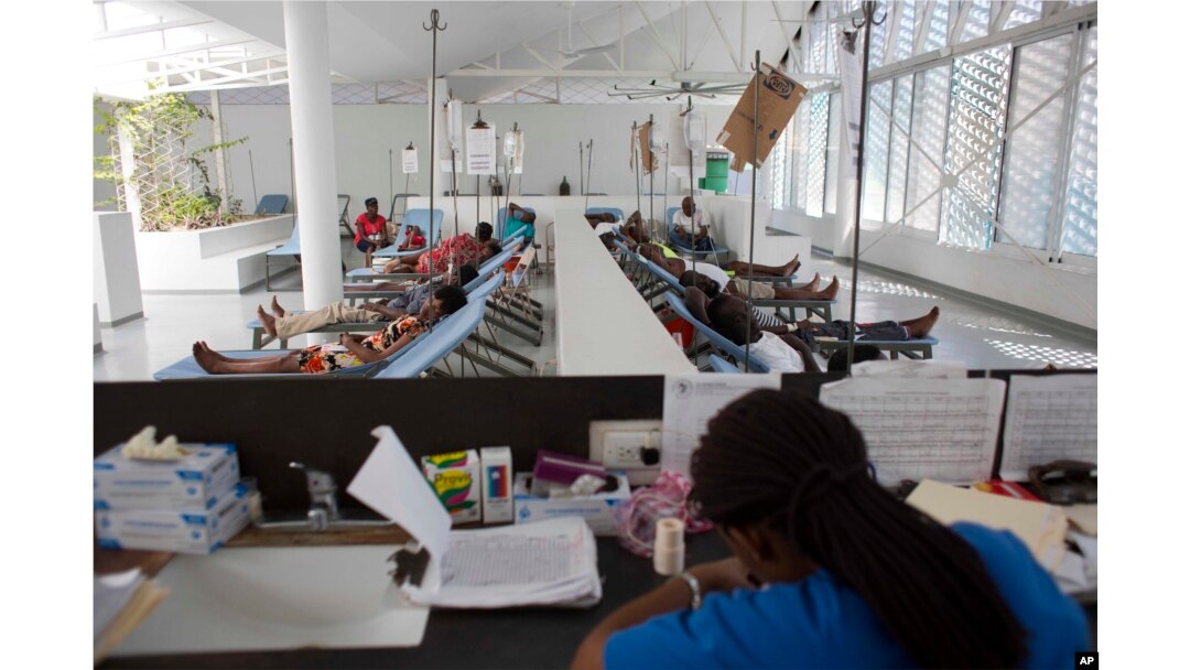 FILE - People get treatment at Haiti's first permanent cholera center, run by Gheskio Centers, in downtown Port-au-Prince, Haiti, Feb. 24, 2016.