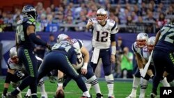 New England Patriots quarterback Tom Brady (12) calls a play against the Seattle Seahawks during the first half of Super Bowl XLIX in Glendale, Arizona, Feb. 1, 2015.