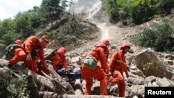 Rescue workers carry a survivor after an earthquake in Jiuzhaigou county, Ngawa prefecture, Sichuan province, China, Aug. 9, 2017.