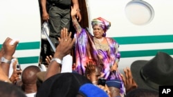 FILE - Patience Jonathan, wife of former Nigeria president Goodluck Jonathan, waves to the crowd upon her arrival at Nnamdi Azikiwe International Airport, in Abuja, Nigeria, Oct. 17, 2012. 