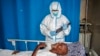 FILE - A medic tends to a patient in a coronavirus ward at Martini Hospital, in Mogadishu, Somalia, May, 13, 2020.