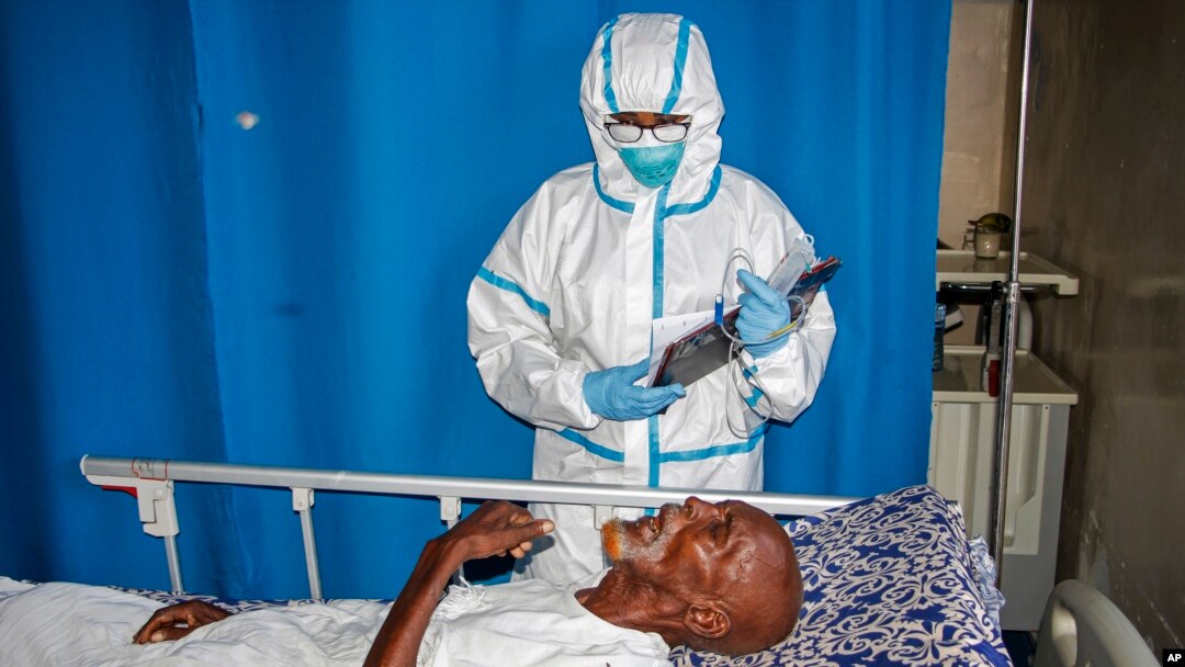FILE - A medic tends to a patient in a coronavirus ward at Martini Hospital, in Mogadishu, Somalia, May, 13, 2020.