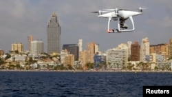 A drone, equipped with a camera used by police for surveillance tasks, flies in front of Poniente beach at the eastern costal town of Benidorm, Spain, Aug.18, 2016. 