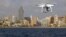 A drone, equipped with a camera used by police for surveillance tasks, flies in front of Poniente beach at the eastern costal town of Benidorm, Spain, Aug.18, 2016. 