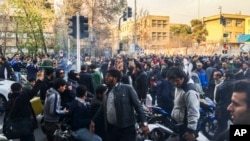 FILE - In this photo taken by an individual not employed by the Associated Press and obtained by the AP outside Iran, demonstrators gather to protest against Iran's weak economy, in Tehran, Iran, Dec. 30, 2017.
