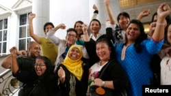 Activists celebrate overturning a sharia law against cross-dressing at the Appeals Court in the Palace of Justice in Putrajaya, Nov. 7, 2014. 