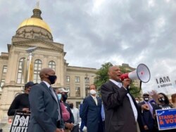 AME Church Bishop Reginald Jackson announces a boycott of Coca-Cola Co. products outside the Georgia Capitol, March 25, 2021, in Atlanta. Jackson says large Georgia companies didn't do enough to oppose restrictive voting bills in the state.