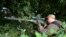 A pro-Russian fighter aims his sniper rifle in Slovyansk, Ukraine, June 11, 2014. 