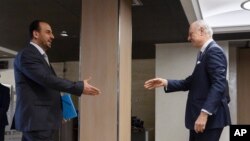 UN Special Envoy for Syria Staffan de Mistura, right, prepares to shake hands with Syria's main opposition High Negotiations Committee leader Nasr al-Hariri upon his arrival for a meeting during Syria peace talks in Geneva, Switzerland, Feb. 27, 2017.