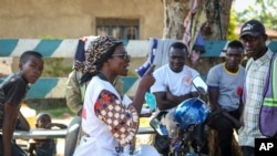 Katungo Methya, 53, who volunteers for the Red Cross educating the public about epidemics, talks about coronavirus prevention in Beni, eastern Congo, April 7, 2020.