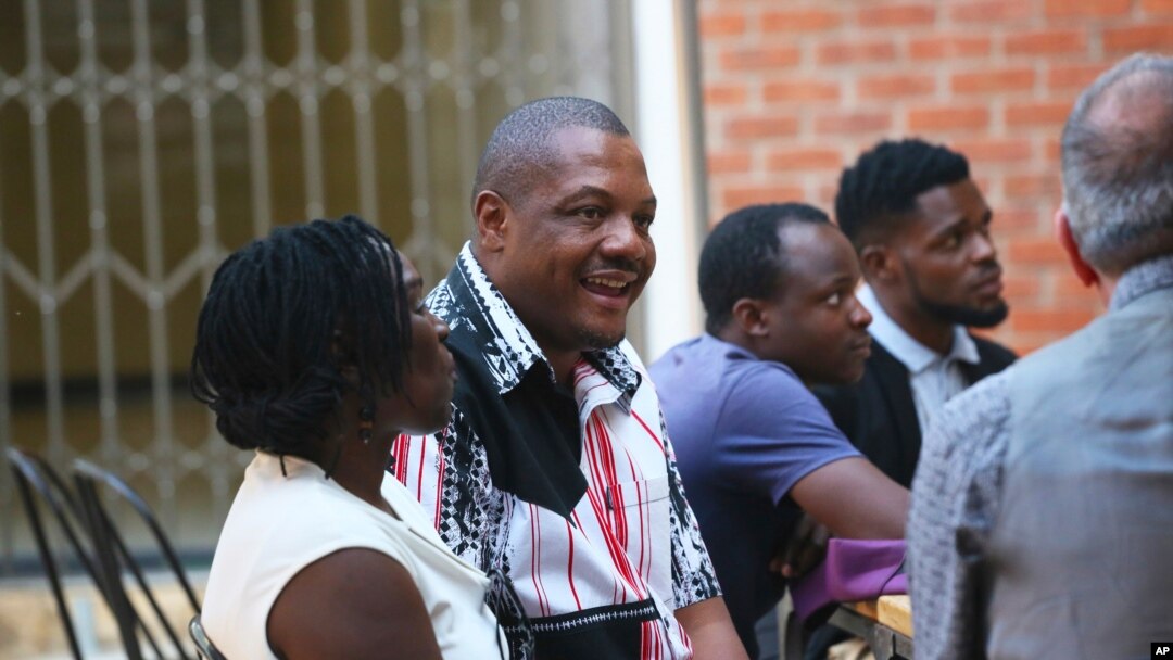 Zimbabwe journalist Hopewell Chino'ono, center, smiles during the launch of his documentary, State of Mind, in Harare, Oct. 10, 2018. 