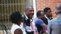 Zimbabwe journalist Hopewell Chino'ono, center, smiles during the launch of his documentary, State of Mind, in Harare, Oct. 10, 2018.