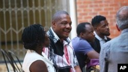 Zimbabwe journalist Hopewell Chino'ono, center, smiles during the launch of his documentary, State of Mind, in Harare, Oct. 10, 2018. 