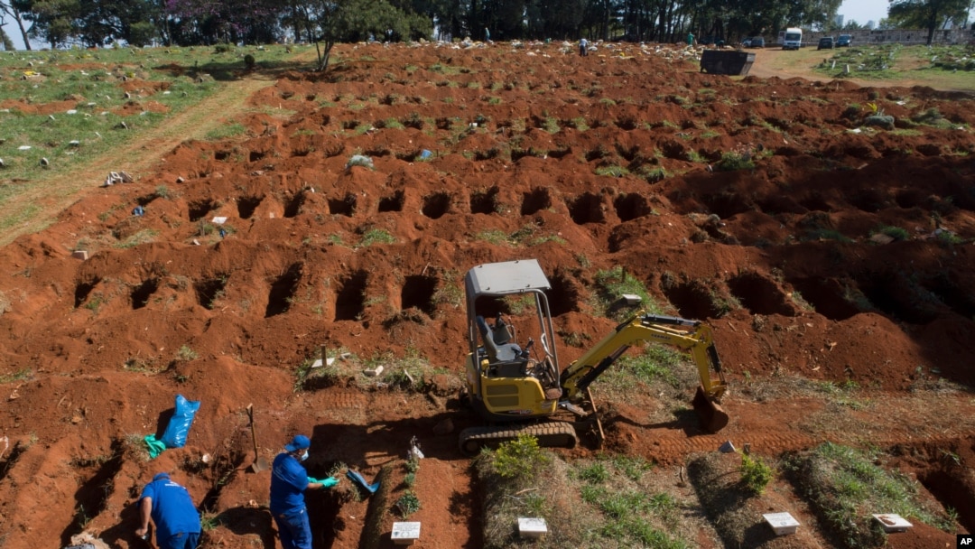 Cemetery workers exhume remains buried three years ago at the Vila Formosa cemetery, which does not charge families for the gravesites, in Sao Paulo, Brazil, June 12, 2020. They're making room for COVID-19 victims.