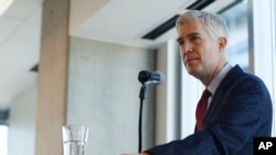 FILE - 10th U.S. Circuit Court of Appeals Judge Neil Gorsuch makes a point while delivering prepared remarks before a group of attorneys at a luncheon in a legal firm in lower downtown Denver, Jan. 27, 2017.