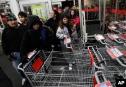 FILE - Shoppers unreserved  into a Kmart store   successful  Chicago connected  Nov. 25, 2011, for the Black Friday sale.