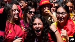 Spanish fans celebrate in a street, in Madrid, Spain, Aug. 20, 2023, after Spain won against England in the Women's World Cup final soccer match played in Australia. 