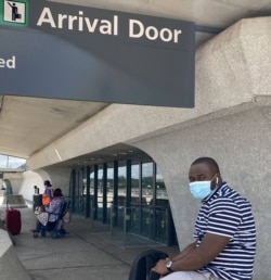 Liberian Francis Massaquoi waits for a ride at Dulles International Airport near Washington, D.C., July 16, 2020. (Aishwarya Airy/VOA)