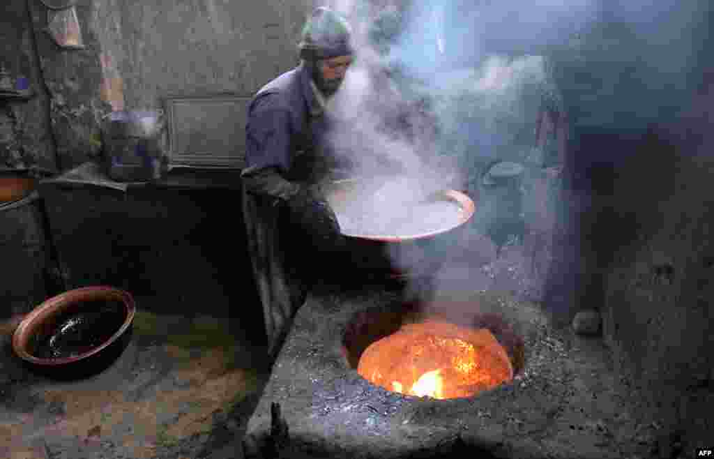 An Afghan employee works at a traditional sweet factory in Ghazni.