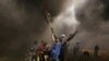 FILE - Palestinian demonstrators shout during clashes with Israeli troops at a protest demanding the right to return to their homeland, at the Israel-Gaza border east of Gaza City, April 6, 2018.