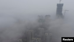 FILE -- Buildings are seen shrouded in heavy haze at Qingdao development zone, Shandong province.
